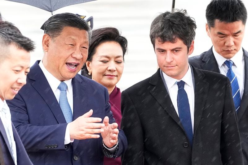 China's President Xi Jinping speaks to French Prime Minister Gabriel Attal as he arrives Sunday, May 5, 2024 at Orly airport, south of Paris. French President Emmanuel Macron will seek to press China's Xi Jinping to use his influence on Moscow to move towards the end of the war in Ukraine, during a two-day state visit to France that will also see both leaders discuss trade issues. (AP Photo/Michel Euler, Pool)