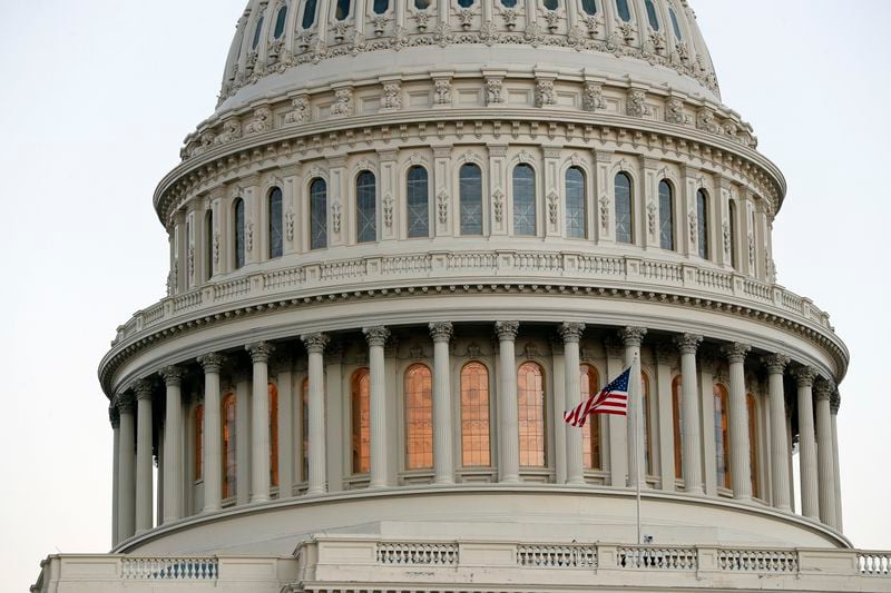 A flag flies at the U.S. Capitol dome in Washington, D.C. (Alex Brandon/AP)