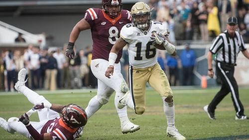 Georgia Tech quarterback TaQuon Marshall (16) runs leaving Virginia Tech defensive end Emmanuel Belmar (40) in the grass and defensive tackle Ricky Walker (8) giving chase during the second half on Saturday, Nov.11, 2017, in Atlanta.
