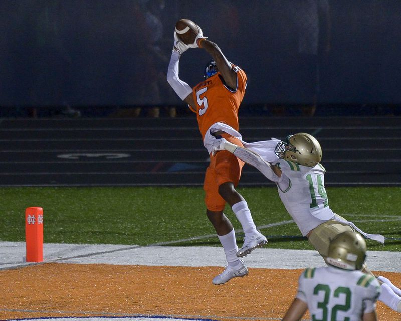 North Cobb wide receiver Christian Moss (5) hauls in a pass against Buford defensive back Jake Pope (14) for a touchdown in the first half Sept 11, 2020, in Kennesaw. (Daniel Varnado/For the AJC)