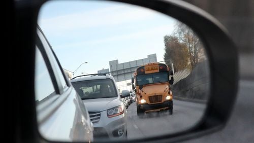 A school bus navigates rush hour traffic on I-75 South on Thursday. At least four school bus crashes take place each day in metro Atlanta. The state Department of Education reports that some Georgia school systems do a poor job of reporting accidents, which makes it hard to pinpoint and solve potential safety issues. Curtis Compton/ccompton@ajc.com