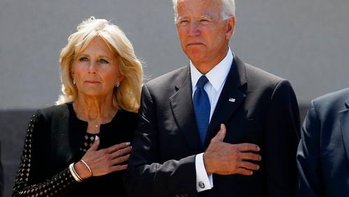 Former Vice President Joe Biden, right, and his wife Jill Biden, pause with hands over their hearts as they watch a military honor guard place the casket of Sen. John McCain, R-Ariz., into a hearse after a memorial service at North Phoenix Baptist Church Thursday, Aug. 30, 2018, in Phoenix. (AP Photo/Ross D. Franklin)