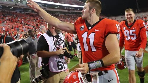 Georgia freshman quarterback Jake Fromm throws his game items to fans after leading the team to a 31-10 victory against Appalachian State in a NCAA college football game on Saturday, September 2, 2017, in Athens.    Curtis Compton/ccompton@ajc.com