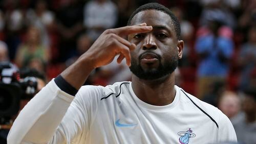 Miami Heat guard Dwyane Wade gestures after the singing of the National Anthem before the start of an NBA basketball game against the Los Angeles Lakers, Thursday, March 1, 2018, in Miami. (AP Photo/Wilfredo Lee)