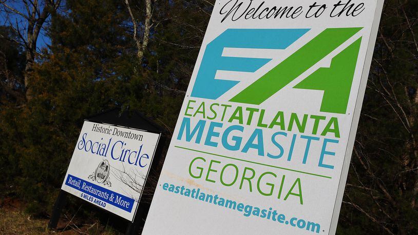 An East Atlanta Megasite sign marking the Rivian project site sits next to sign for the historic downtown of Social Circle, Georgia, on Tuesday, Jan. 18, 2022. (Curtis Compton/Atlanta Journal-Constitution/TNS)