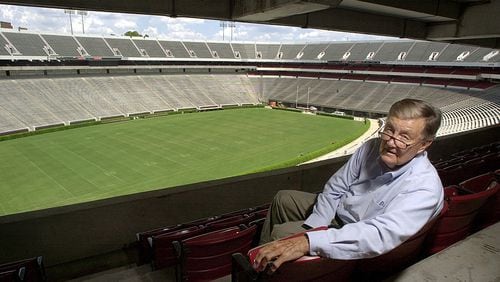 In this file photo taken Aug. 19, 2002, Larry Munson, the play-by play announcer for the Georgia Bulldogs sits inside Sanford Stadium in Athens, Ga.