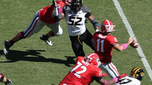 October 12, 2013 - Athens, Ga: Missouri Tigers defensive lineman Michael Sam (52) puts pressure on Georgia Bulldogs quarterback Aaron Murray (11) as Georgia Bulldogs offensive tackle Kolton Houston (75) attempts to block during their game at Sanford Stadium Saturday afternoon in Athens, Ga., October 12, 2013. Missouri defeated Georgia 41-26. Murray threw for 290 yards, 3 touchdowns, 2 interceptions and had a fumble returned for a touchdown in the loss. JASON GETZ / JGETZ@AJC.COM Michael Sam rushes Aaron Murray. (Jason Getz/AJC)