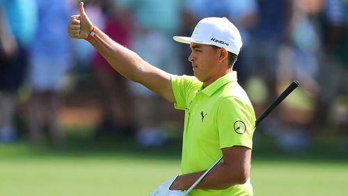 Rickie Fowler gives the gallery a thumbs up hitting his fairway shot close to the cup on the third hole on his way to a birdie during his practice round for the Masters at Augusta National Golf Club on Monday, April 2, 2018, in Augusta.  Curtis Compton/ccompton@ajc.com