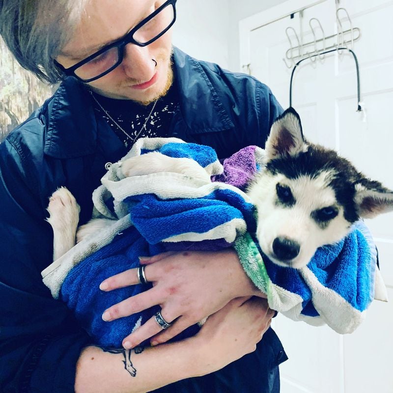 Ian Wrifford, who died in March of 2023, is shown here with his Husky Yuki as a puppy. His mother asked other moms in an online support community to share photos  of their late sons and their dogs. Hundreds did. 