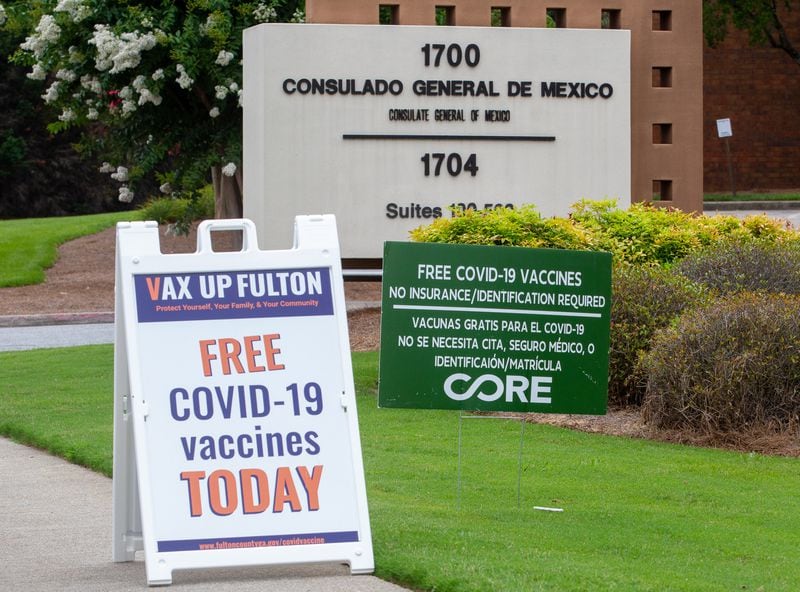 Bilingual signs regarding the vaccination operation sit outside the Mexican consulate in Atlanta on July 16, 2021.STEVE SCHAEFER FOR THE ATLANTA JOURNAL-CONSTITUTION