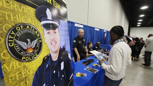 The Atlanta Police department recruited at a job fair last October. But government employment in metro Atlanta fell in January. BOB ANDRES /BANDRES@AJC.COM