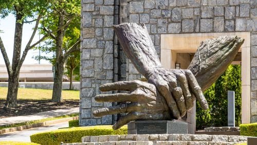 At Marietta's Life University, the nation's largest chiropractic school, a traditional, philosophy-based form of chiropractic dominates, promoting spinal adjustments and healthy living as the best protections against disease. Seen here is the campus's sculpture of the hands of founder Sid Williams. (Jenni Girtman for The Atlanta Journal Constitution)