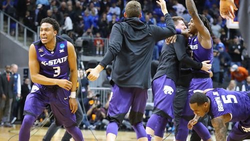 March 23, 2018 Atlanta: Kansas State guard Kamau Stokes and teammates celebrate beating Kentucky 61-58 in a regional semifinal NCAA college basketball game on Friday, March 23, 2018, in Atlanta.  Curtis Compton/ccompton@ajc.com