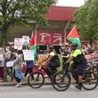Pro-Palestinian protesters march on Joseph E Lowery Blvd as they are escorted by Atlanta Police Bike Patrol officers next to Morehouse College as President Joe Biden speaks during the 140th commencement ceremony on Sunday, May 19, 2024. (Jason Getz / AJC)
