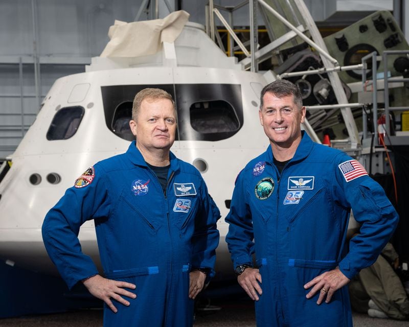 Astronauts Eric Boe (left) and Robert Shane Kimbrough stand with a mock-up of the Orion spacecraft at NASA s Johnson Space Center in Houston.