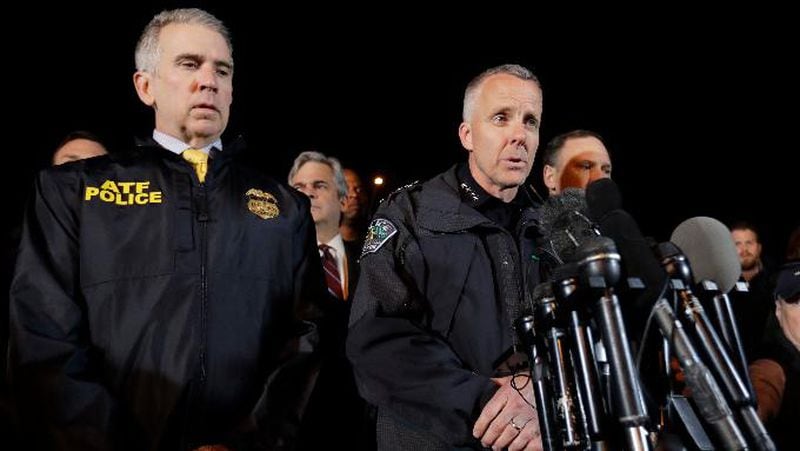 Interim Austin Police Chief Brian Manley, right, stands with other members of law enforcement as he briefs the media, Wednesday, March 21, 2018, in the Austin suburb of Round Rock, Texas. The suspect in a spate of bombing attacks that have terrorized Austin over the past month blew himself up with an explosive device as authorities closed in, the police said early Wednesday. 