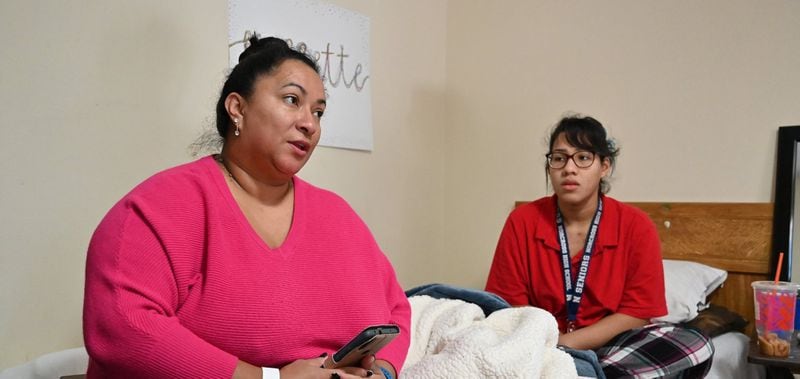 Maria Fernandez and her daughter in the motel room that has been their home for years. They hope for a move to an apartment in April -- with help from a pilot program.