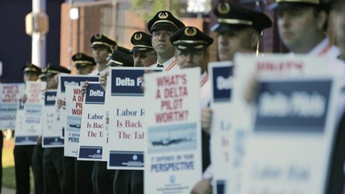 Delta Air Line pilots, represented by the Air Line Pilots Association, picketed at Delta headquarters in September. Contract negotiations took more than 19 months. BOB ANDRES /BANDRES@AJC.COM
