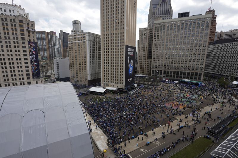 Fans stand near the draft stage during the third day of the NFL football draft, Saturday, April 27, 2024, in Detroit. (AP Photo/Paul Sancya)