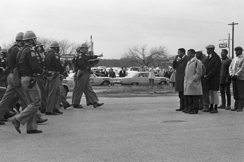 Congressman John Lewis (right side, with tan coat) and Hosea Williams are shown moments before they were attacked by Alabama state troopers on March 7, 1965. It’s a day that would be known as “Bloody Sunday.” CONTRIBUTED BY MAGNOLIA PICTURES