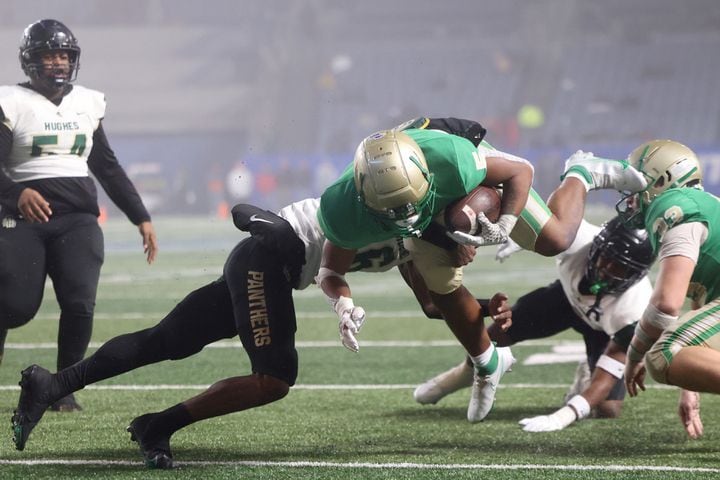Buford running back CJ Clinkscales (5) scores a touchdown against Langston Hughes defensive back Rodney Shelley (6) during the first half of the Class 6A state title football game at Georgia State Center Parc Stadium Friday, December 10, 2021, Atlanta. JASON GETZ FOR THE ATLANTA JOURNAL-CONSTITUTION