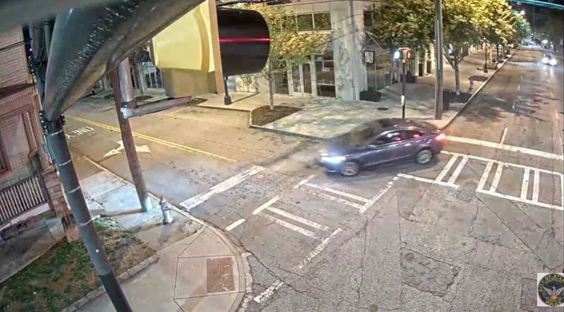 Atlanta police have released surveillance footage of a four-door sedan sought in connection with the robbery and fatal shooting of a 35-year-old father of two.