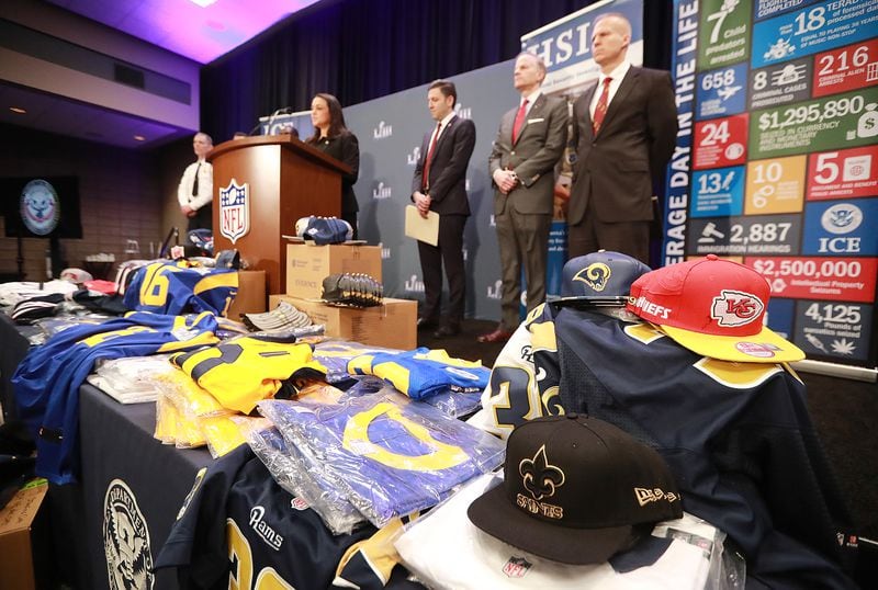 Fake NFL merchandise covers a table as the National Football League and law enforcement agencies announce the latest results of seizures of counterfeit game-related merchandise and tickets during a press conference at the Georgia World Congress Center on Thursday, Jan. 31, 2019, in Atlanta. Curtis Compton/ccompton@ajc.com