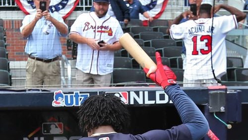 Braves' Ronald Acuna Jr. recognizes cheering Braves fans, one wearing his jersey, in 2019.