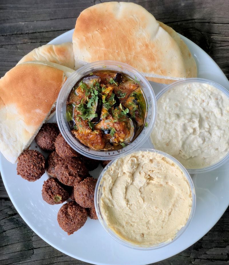 This assortment of appetizers from Cafe Raik includes fried eggplant, baba ghanoush, hummus, falafel and pita. Wendell Brock for The Atlanta Journal-Constitution