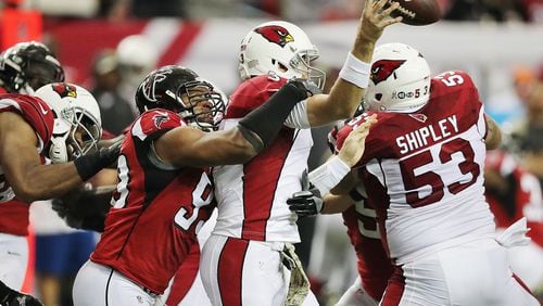 Falcons defensive end Dwight Freeney hits Arizona quarterback Carson Palmer to force an incomplete pass during the fourth quarter of a game on Nov. 27. It was the Falcons’ first game after the bye, which allowed Freeney a chance to rest a torn quad. (Curtis Compton/ccompton@ajc.com)
