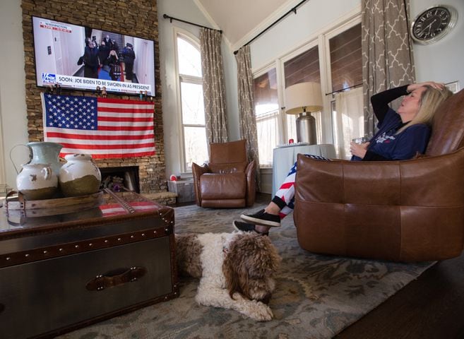 Meredith Davidenko, long-time Republican and Trump supporter, watches the inauguration of President Biden with her children at their Cumming home Wednesday, Jan 20, 2021.  (Jenni Girtman for The Atlanta Journal-Constitution)