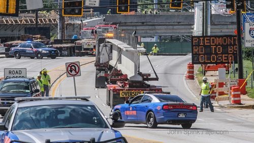 Piedmont Road is closed for 24 hours so crews can continue work to rebuild the I-85 bridge, according to the Georgia Department of Transportation. The road closed at 9 a.m. Tuesday. JOHN SPINK / JSPINK@AJC.COM