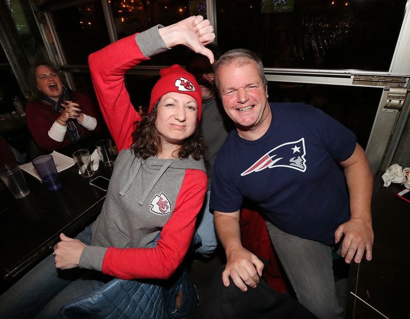 Chiefs fan Becky Taylor and Patriots fan Patrick Hughes face off while watching the AFC Championship game at Midway Pub with a trip to the Super Bowl in Atlanta on the line on Sunday, Jan. 20, 2019, in Atlanta.  (Photo: Curtis Compton/ccompton@ajc.com)