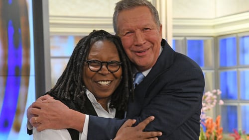 Ohio Gov. John Kasich and Whoopi Goldberg embrace during  Thursday's airing of "The View" on ABC.