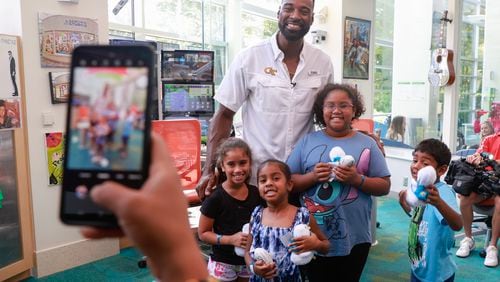 NFL Hall of Famer and former Georgia Tech player Calvin Johnson takes a photo with Ariana Temple, 6, and her siblings Anjali, 4, Avani, 9, and George, 6 while visiting cancer patients at Egleston Children’s Hospital in Atlanta on Friday, September 1, 2023. The siblings all have Li Fraumeni Syndrome (LFS), a rare heredity disorder that increases the risk of of developing different types of cancer. Natrice Miller/ Natrice.miller@ajc.com) 