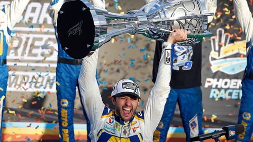 Ah, good times: Chase Elliott holds up the season championship trophy after winning in Phoenix last year. (Ralph Freso/AP)
