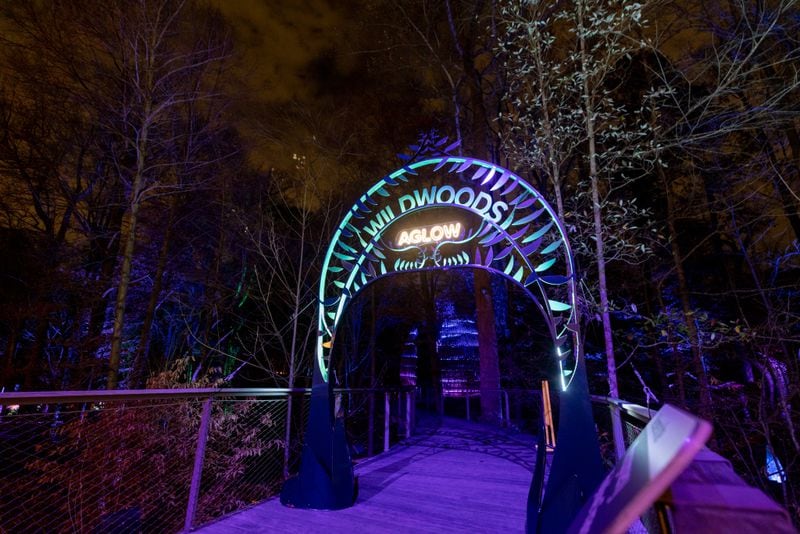 A illuminated neon sign signals the entrance to the Wildwoods: AGLOW Experience at the Fernbank Museum in Atlanta, GA, on Friday, December 2, 2022.(Photo/Jenn Finch)
