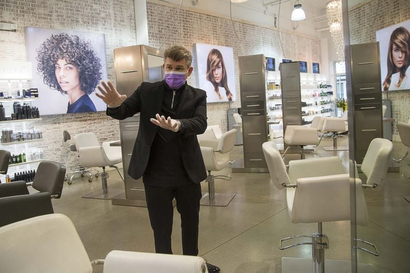 Salon Gloss owner Tim Timmons goes over the new procedures that his staff and guests will adhere to as he reopens the salon during the COVID-19 pandemic in Woodstock, Thursday, April 23, 2020. (ALYSSA POINTER / ALYSSA.POINTER@AJC.COM)