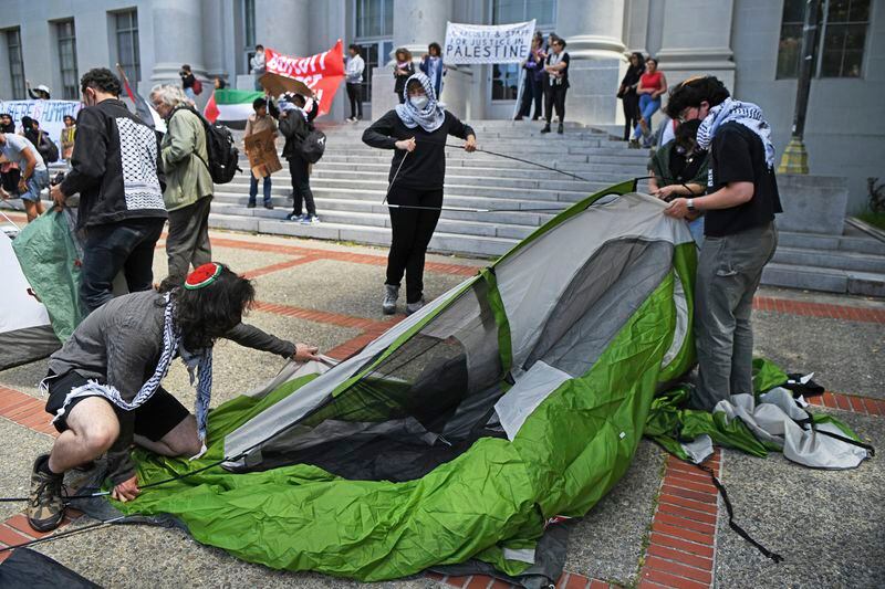 Pro-Palestinian protesters begin to set up tents in front of Sproul Hall during a planned protest on the campus of UC Berkeley in Berkeley, Calif., on Monday, April 22, 2024. Hundreds of pro-Palestinian protesters staged a demonstration in front of Sproul Hall where they set up a tent encampment and are demanding a permanent cease-fire in the war between Israel and Gaza. (Jose Carlos Fajardo/Bay Area News Group via AP)
