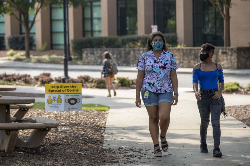 08/17/2020 - Kennesaw, Georgia - Kennesaw State University freshmen Simone Wilson (left) and Zee Agnew (right) wear masks as they walk through campus during the first day of classes at Kennesaw State University's main campus in Kennesaw, Monday, August 17, 2020. (ALYSSA POINTER / ALYSSA.POINTER@AJC.COM)