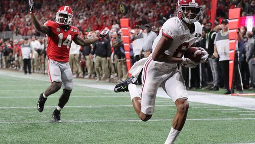 Alabama wide receiver Devonta Smith catches the game-winning touchdown pass past Georgia defensive back Malkom Parrish for a 26-23 victory during overtime in the college football playoff championship game Monday in Atlanta. Curtis Compton/ccompton@ajc.com