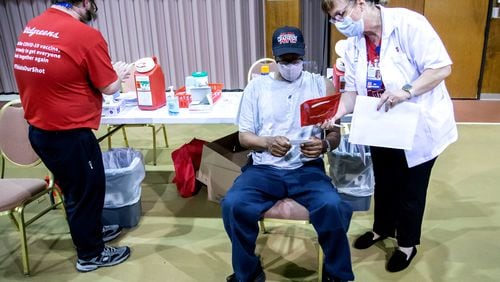 Larry Goch receives instructions before getting his vaccination shot at the Jackson Memorial Baptist Church, where shots were offered through a partnership with Walgreens. (Steve Schaefer for The Atlanta Journal-Constitution)
