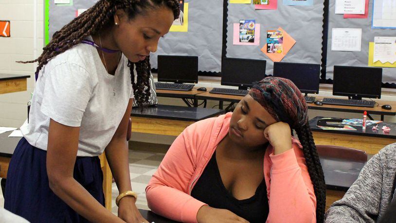 Sascha Brown (left) helps her student Alexia Mitchell during their environmental science class at the S.T.E.A.M. Academy at Carver High School on Thursday, Aug. 2. The S.T.E.A.M. Academy at Carver High School started the new year with its new project-based program. JENNA EASON / Jenna.Eason@coxinc.com