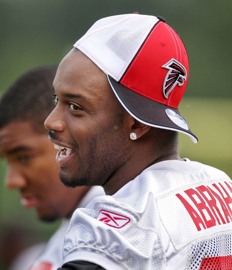 Falcons defensive end  John Abraham, sidelined with an ankle injury, has a laugh as he watches team practice at training camp in Flowery Branch, Thursday,  August 14, 2008.  Curtis Compton/ AJC