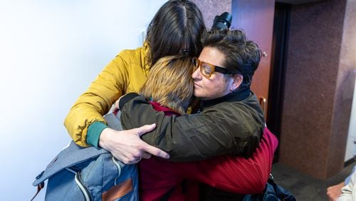Royce Soble, a trans activist, embraces their partner and friend following the passage of SB 140, a bill that would limit treatment for transgender youth, at a House Public Health Committee Meeting at the Paul D. Coverdell Legislative Office Building in Atlanta on Tuesday, March 14, 2023. (Arvin Temkar / arvin.temkar@ajc.com)