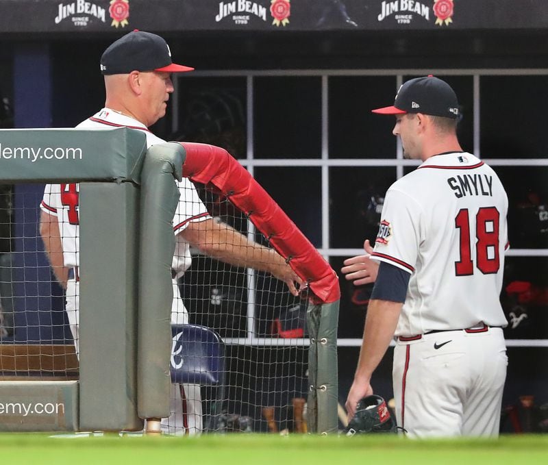 Braves manager Brian Snitker gives starting pitcher Drew Smyly five after he goes six innings against the Cincinnati Reds in a MLB baseball game on Tuesday, August 10, 2021, in Atlanta.   “Curtis Compton / Curtis.Compton@ajc.com”
