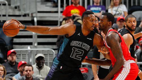 Dwight Howard #12 of the Charlotte Hornets looks to drive against Dewayne Dedmon #14 of the Atlanta Hawks at Philips Arena on January 31, 2018 in Atlanta, Georgia.  (Photo by Kevin C. Cox/Getty Images)