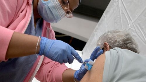 A woman is administered a dose of COVID-19 vaccine in 2021. (PHOTO by Anthony Behar/Sipa USA/TNS)