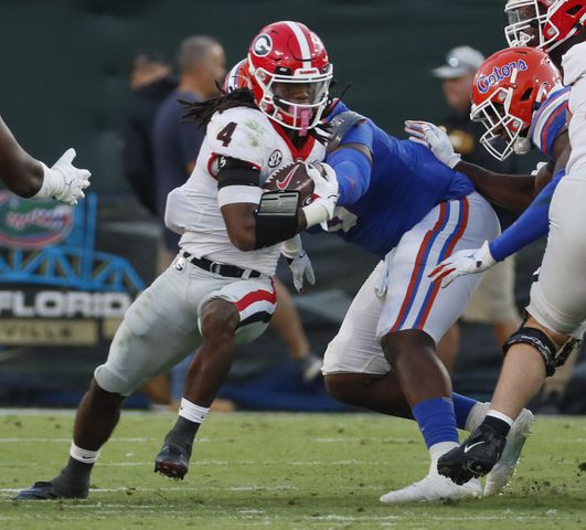 10/30/21 - Jacksonville -  Georgia Bulldogs running back James Cook (4) runs for a first down during the second half of the annual NCCA  Georgia vs Florida game at TIAA Bank Field in Jacksonville. Georgia won 34-7.  Bob Andres / bandres@ajc.com