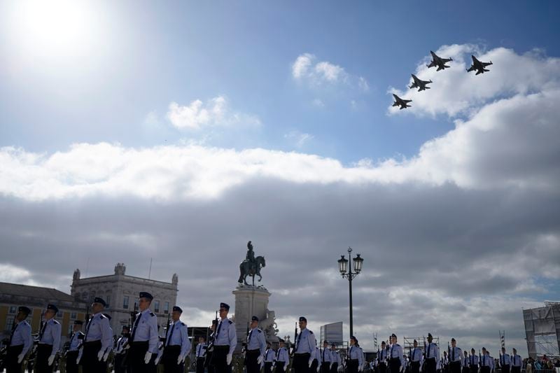 Portuguese Air Force F-16 fighter jets fly over Lisbon's Comercio square, Thursday, April 25, 2024, during celebrations of the fiftieth anniversary of the Carnation Revolution. The April 25, 1974 revolution carried out by the army restored democracy in Portugal after 48 years of a fascist dictatorship. (AP Photo/Armando Franca)